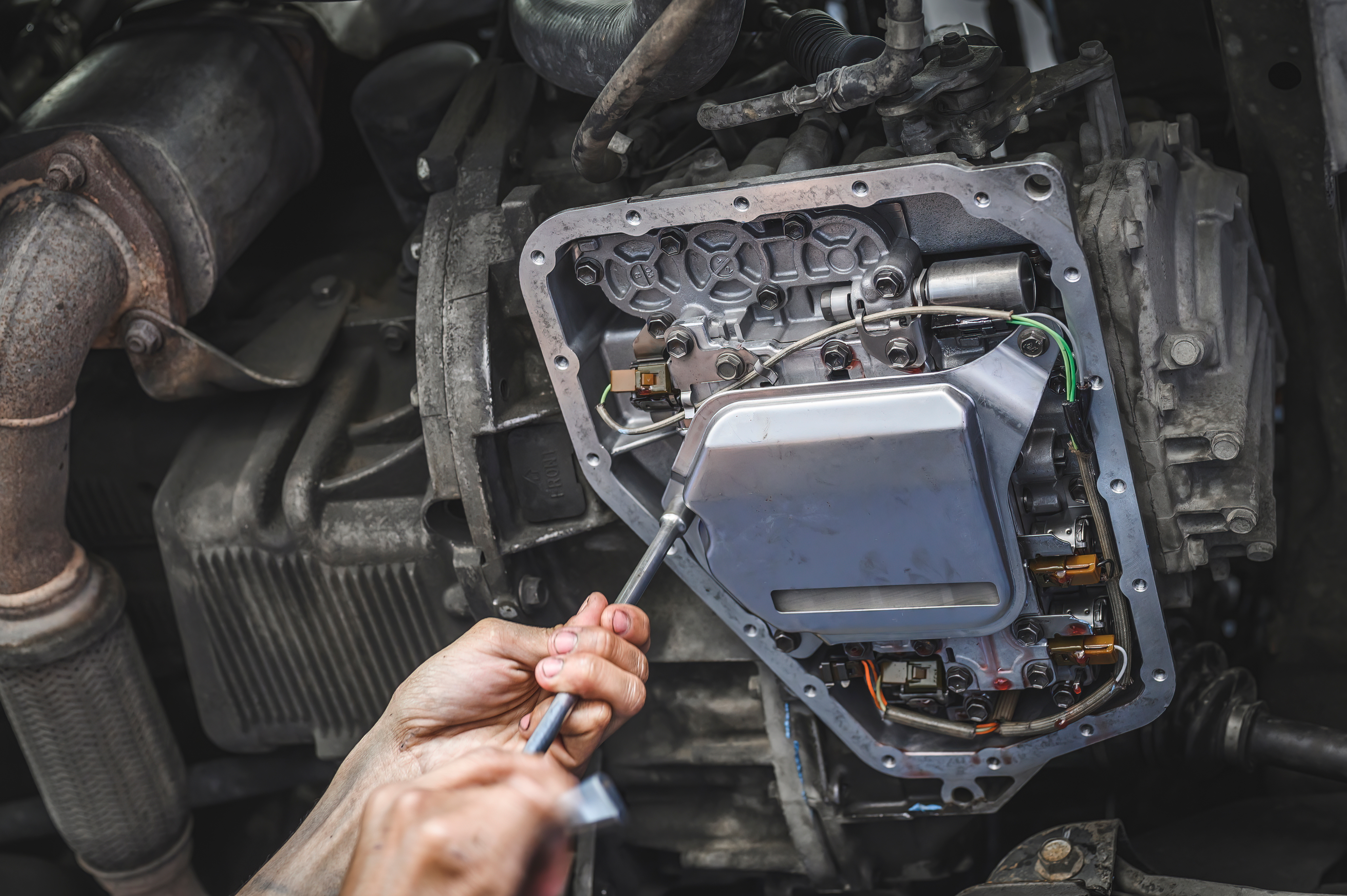 Technician rebuilding a transmission valve body